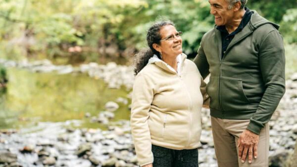 Two seniors walk in the forest