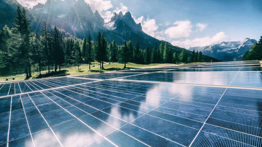 A solar cell panel generates power in a country mountain landscape.