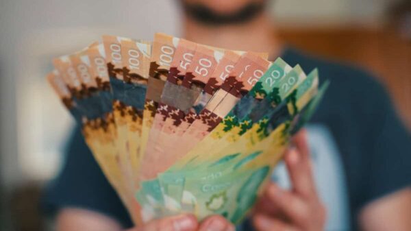 Person holds banknotes of Canadian dollars