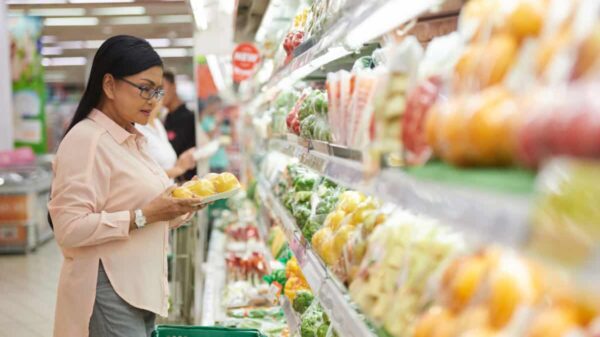 shopper chooses vegetables at grocery store