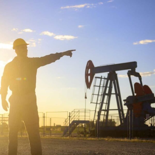 Oil industry worker works in oilfield