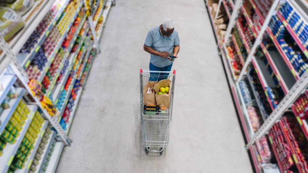 man shops at grocery store