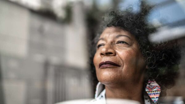 woman gazes forward out window to future
