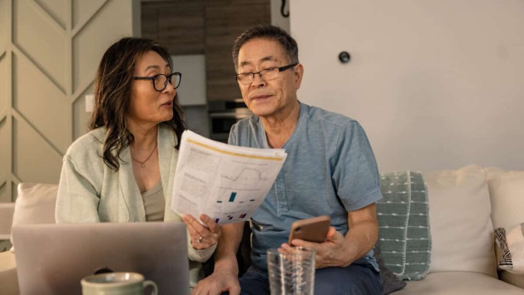 senior couple looks at investing statements