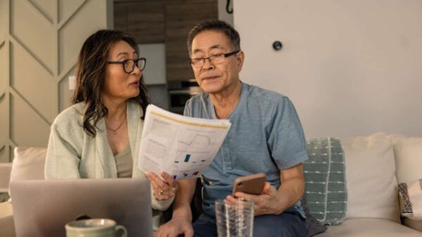 senior couple looks at investing statements